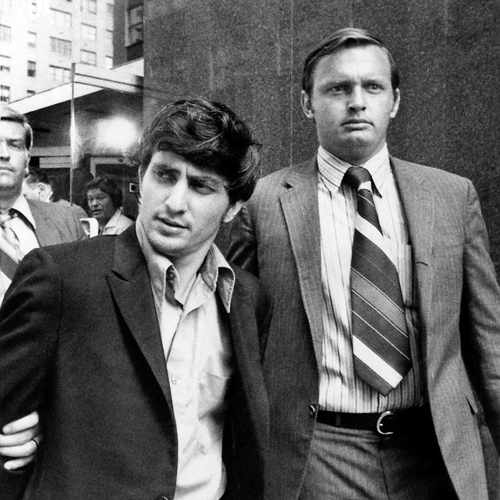 FBI Agent escorts bank robber to jail in NYC.